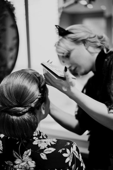 Cona bei der Brautfrisur Cona beim Styling einer eleganten Braut-Steckfrisur im Friseursalon